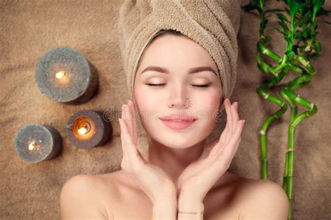 beautiful spa woman   towel   head lying  touching face