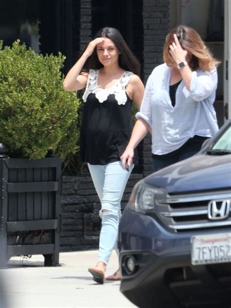 mila kunis is bumping along nicely as she nails pregnancy chic in pretty lace trimmed top