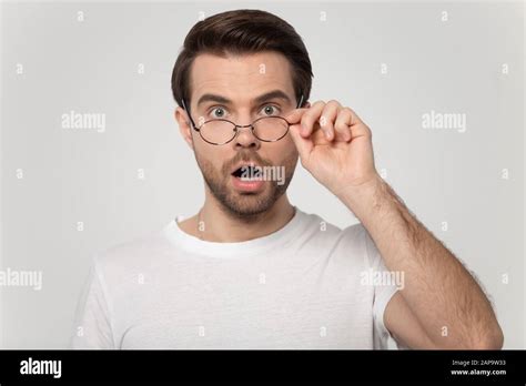 Young Shocked Surprised Man Looking At Camera Taking Off Glasses Stock