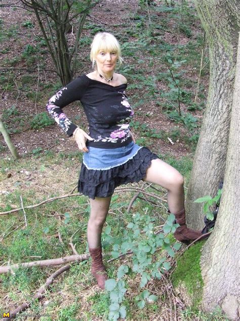 blonde mature slut playing naked in the forest
