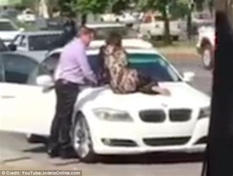 wife sits on her cheating husband s bmw to stop him driving off with his mistress daily mail