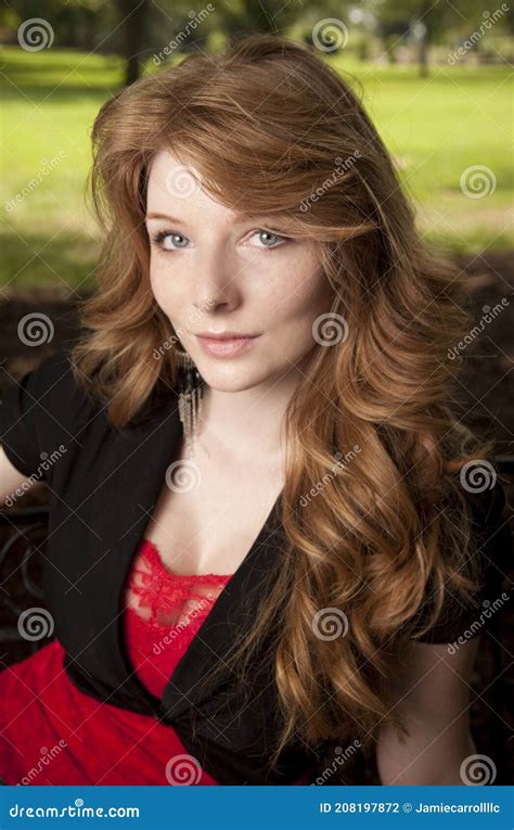 portrait of a beautiful woman with long red hair and green eyes stock