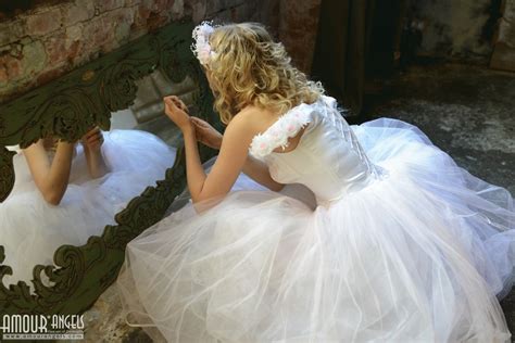 nika model in wedding dress looking in mirror lambstew