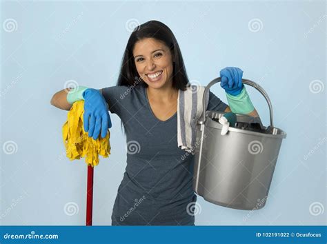 hispanic woman happy proud as home or hotel maid cleaning and ho stock