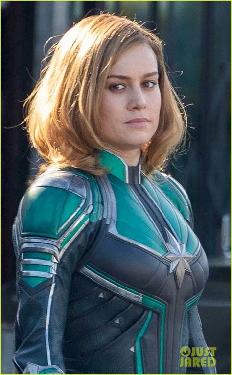 brie larson gets into her superhero costume as captain marvel see