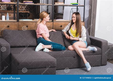 Zwei Junge Freundinnen Die Miteinander Beim Sitzen Auf Sofa Sprechen