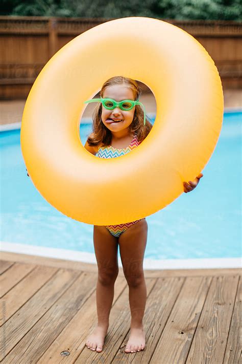 cute young girl playing    tube   pool  stocksy contributor jakob lagerstedt