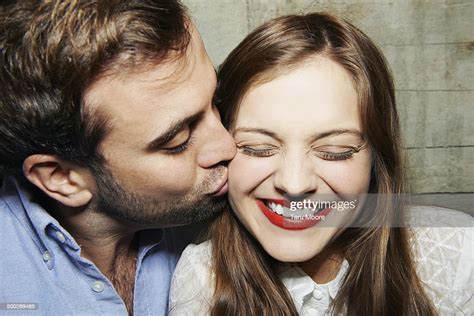 man kissing woman on cheek photo getty images