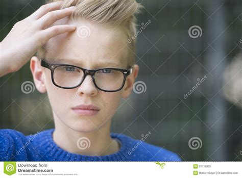 portrait confident blond teenager with glasses stock image