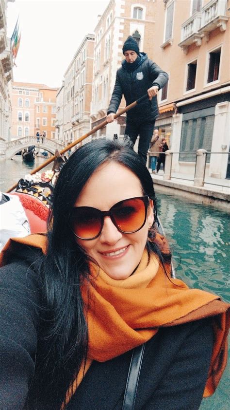 a woman taking a selfie while riding a gondola