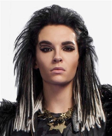 a man with long black hair and white dreadlocks on his head wearing a