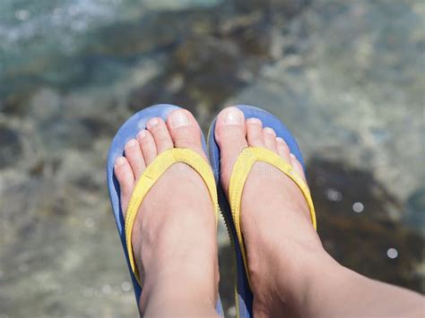 Selfie Bare Feet Wearing Colorful Sandal Over Sea Water Background