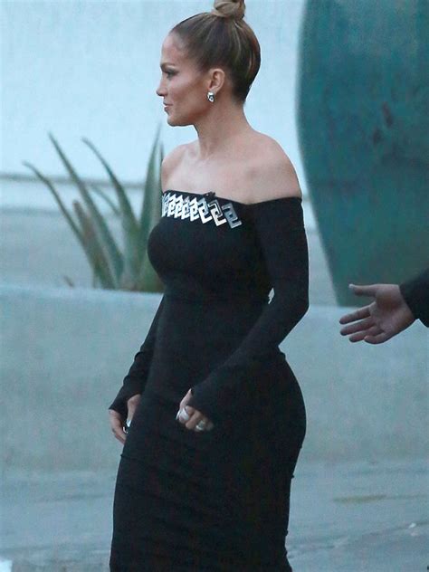 jennifer lopez struggles to contain her curves in skintight zip up dress