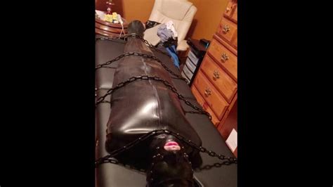 hairless rubber gimp slave plugged and in chastity training