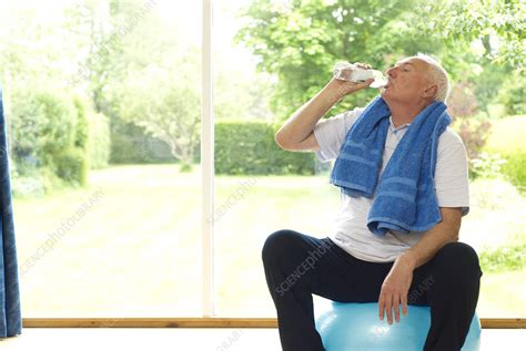 Older Man Drinking Water During Exercise Stock Image