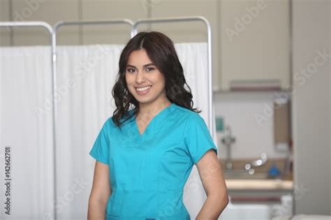 Portrait Of A Young Attractive Hispanic Healthcare Worker Nurse In