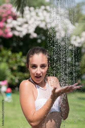 girl wear bikini standing   outdoor pool shower playful time