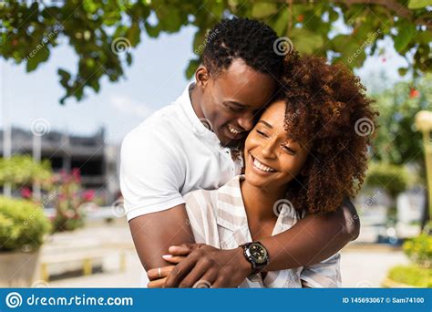 Outdoor Protrait Of African American Couple Embracing Each Other Stock