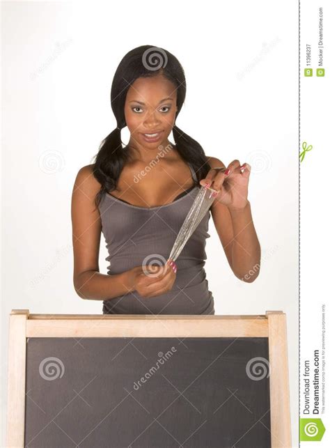 african american woman with condom by blackboard royalty