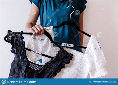 Tidying Up Concept Woman Holding Clothes Hangers With Black And White