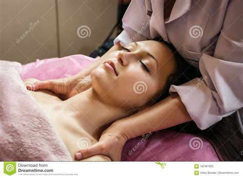 calm girl having spa facial massage in luxurious beauty salon stock