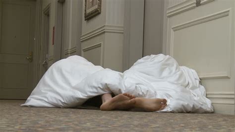 Couple Resort To Sleeping In Hotel Corridor Feet Appear