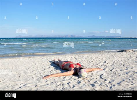 mid adult woman sunbathing  beach alcudia mallorca spain europe stock photo alamy