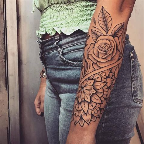 a woman with a rose tattoo on her arm