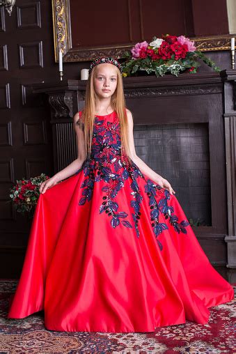 cute little redhead girl wearing an antique princess dress or costume