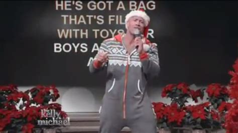 Here Is A Video Of The Rock Singing Here Comes Santa Claus In A Onesie