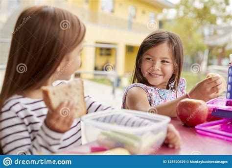 Schoolgirls Eating Apples Relaxing Schoolyard Refuse To Eat Concept