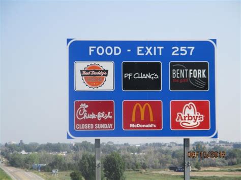 ever wonder how do businesses get their names on highway service signs