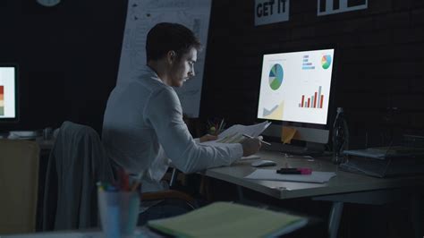 overworked business man analyzing financial chart and diagram in night