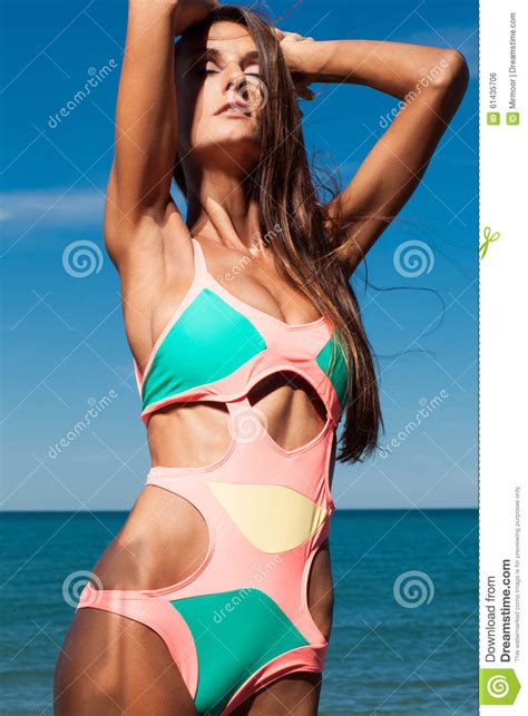 attractive girl enjoys hot summer day at the beach stock