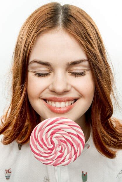 Premium Photo Attractive Red Haired Woman Licking Lollipop Face Fun
