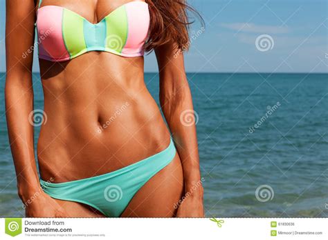 attractive girl enjoys hot summer day at the beach stock