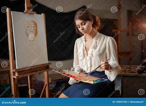 female painter holds color palette  brush stock photo image