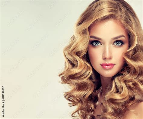 beautiful girl blonde hair with an elegant hairstyle hair wave curly