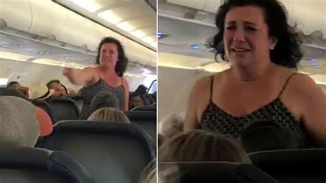 agitated woman seen screaming along airplane aisle in meltdown caught