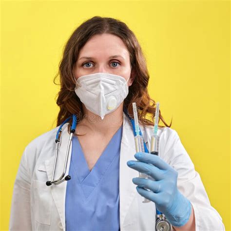 Woman Doctor With Insulin Syringes In Hand On A Yellow Background Copy