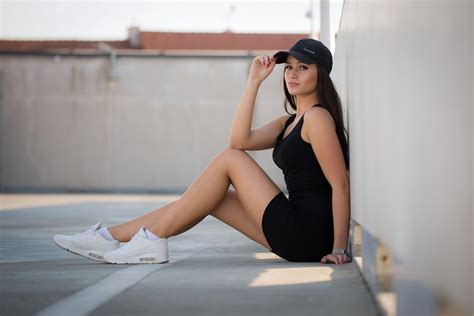 wallpaper women portrait sitting black dress sneakers baseball caps brunette red nails