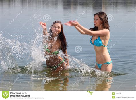 Two Girls In Bikini Play In A Water Stock Image Image Of