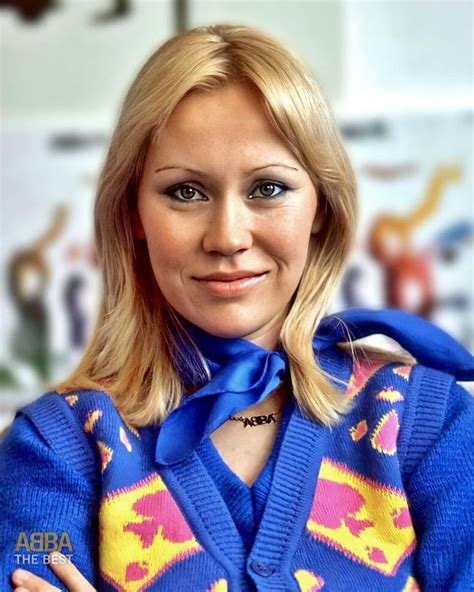 A Woman With Her Arms Crossed Wearing A Blue Sweater