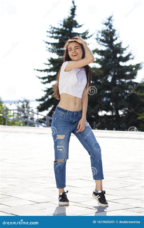 Young Beautiful Teenager Girl Posing Against Summer Park Bright Sunny