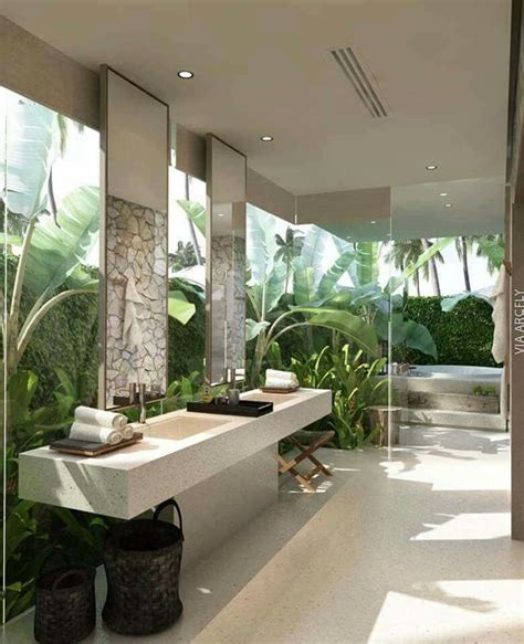 i love all the natural light and greenery in this bathroom