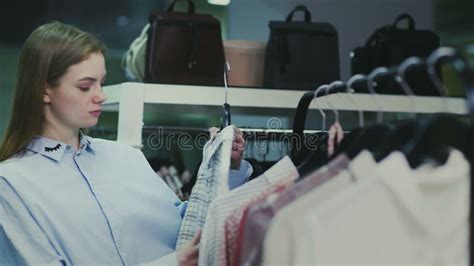 A Cute Girl Chooses Clothes In A Store Shopping Stock Video Video Of