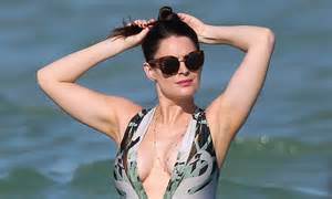 susie amy is extremely busty in a super plunge swimsuit