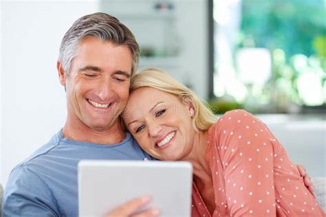 Bonding And Browsing A Mature Couple Relaxing With Their Digital
