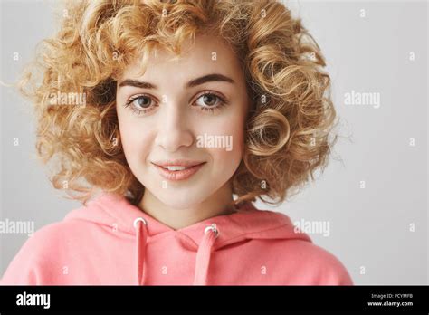 Indoor Shot Of Cute Curly Haired Caucasian Female With Angel Expression