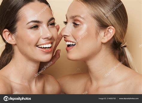 Optimistic Beautiful Blonde And Brunette Women Talking With Each Other